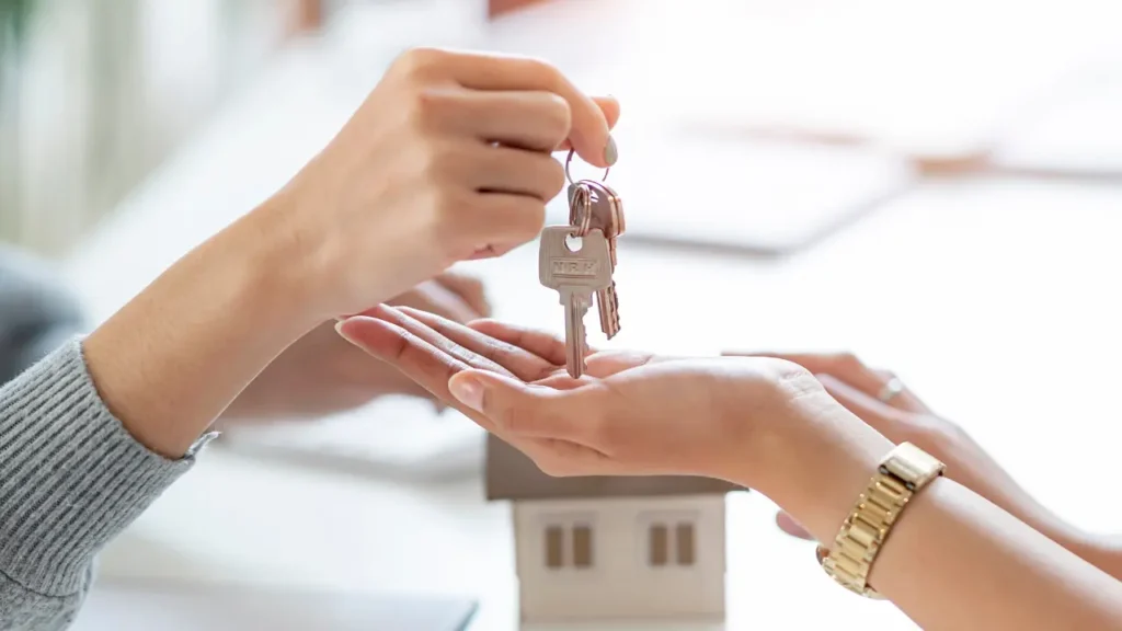 Hands giving set of keys to another set of hands